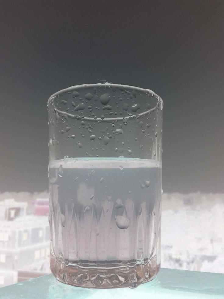 Glass of clear cold water is half full photo