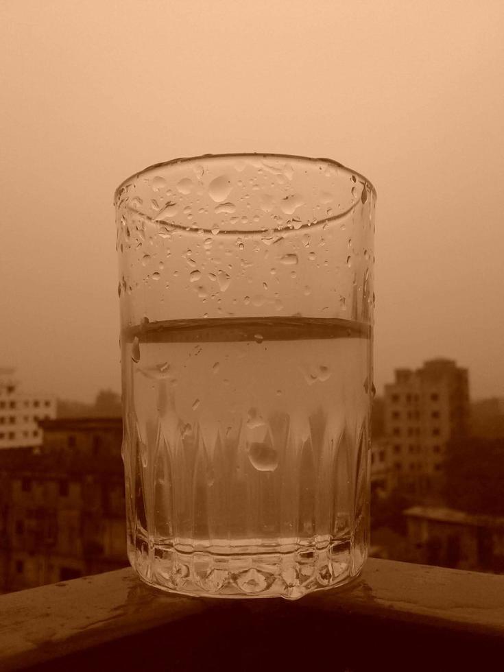 Glass of clear cold water is half full photo