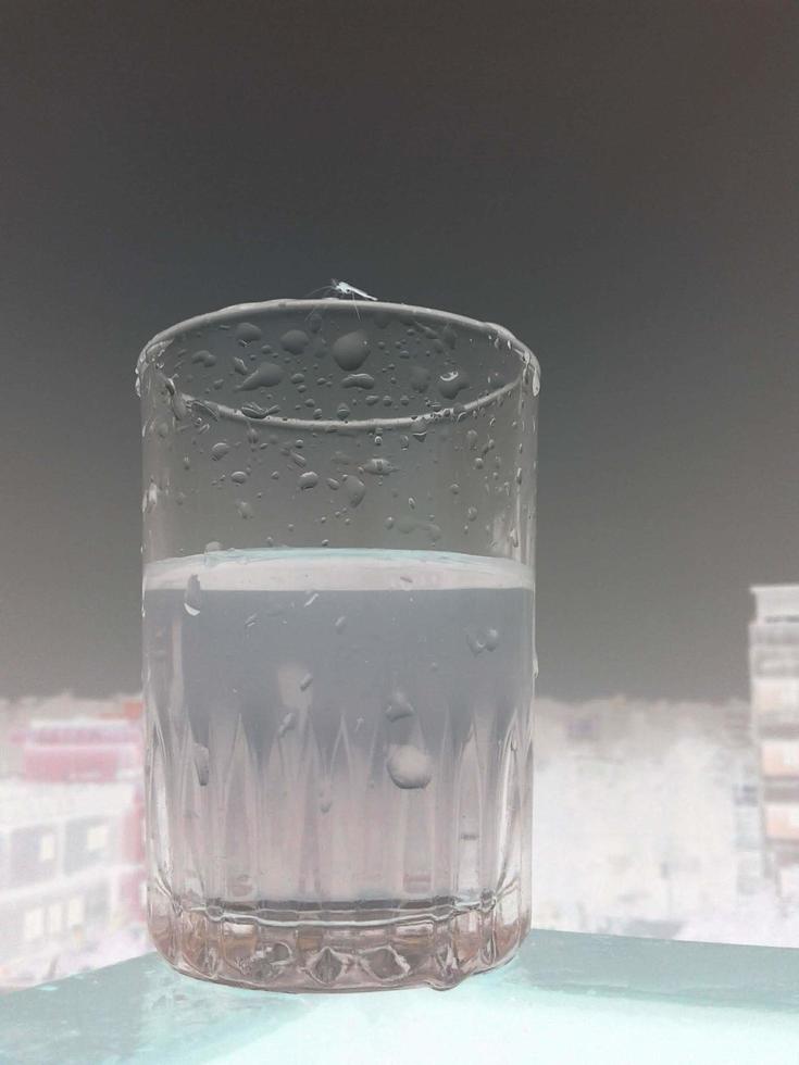 Glass of clear cold water is half full photo