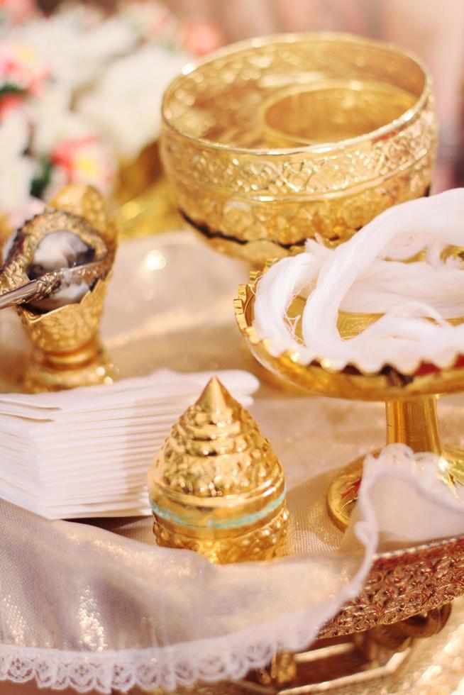 Golden conch set and flower garlands for Thai water pouring wedding ceremony photo