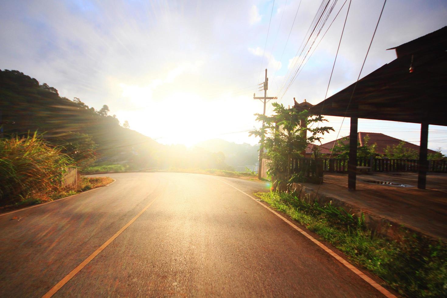 Winding road with beautiful sunrise on the mountain photo