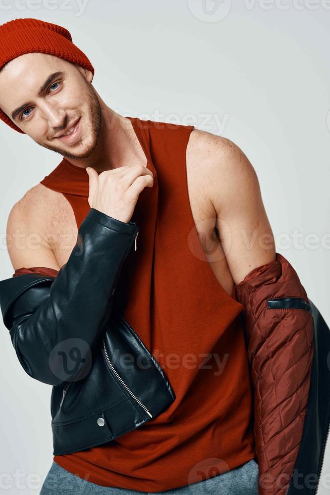 cute fashion men in red hat leather jacket posing modern style photo