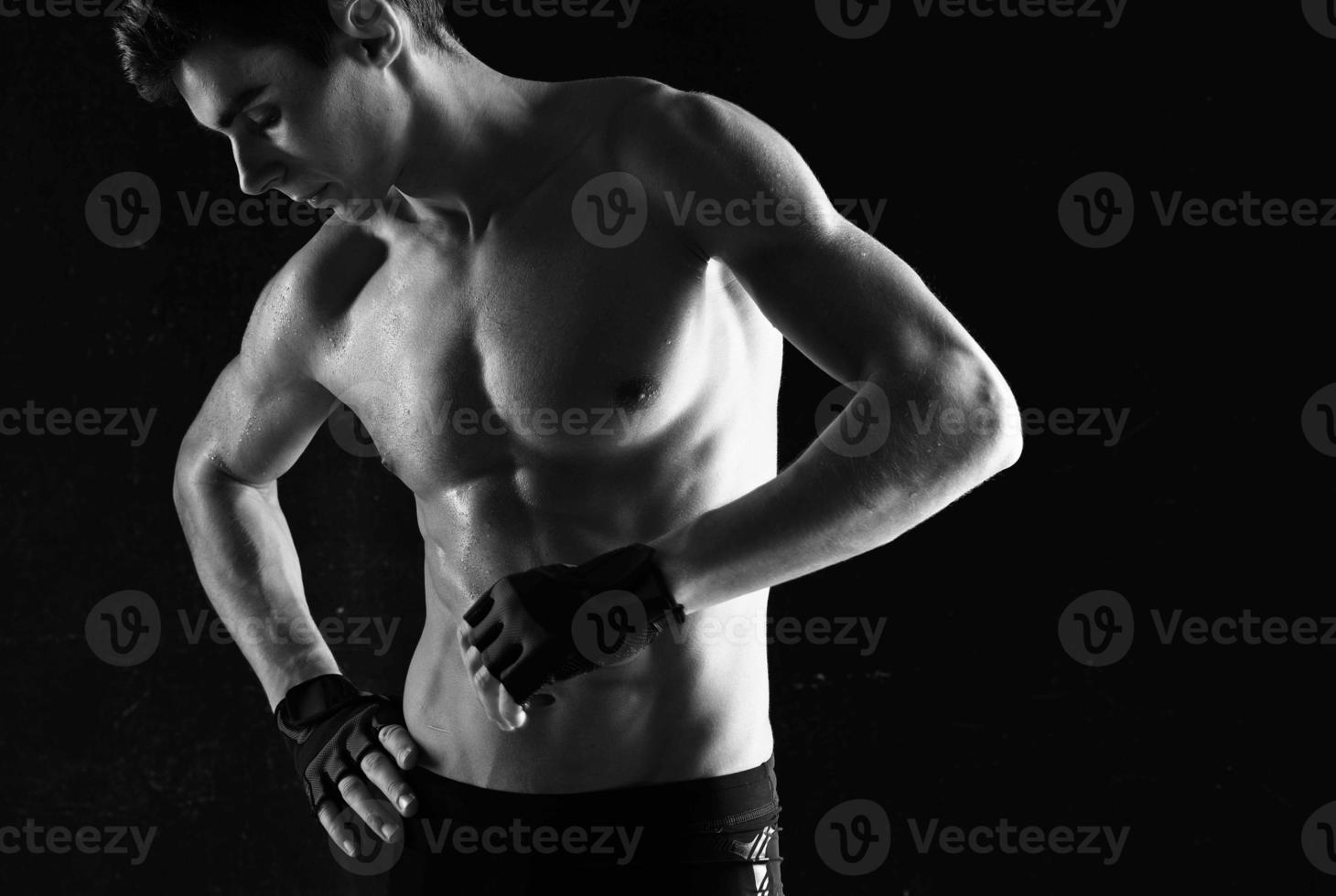 man with a pumped-up torso workout exercise sport dark background photo