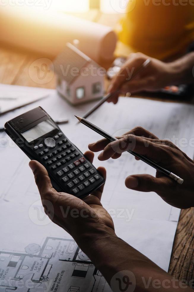 Construction and structure concept of Engineer or architect meeting for project working with partner and engineering tools on model building and blueprint in working site, contract for both companies. photo
