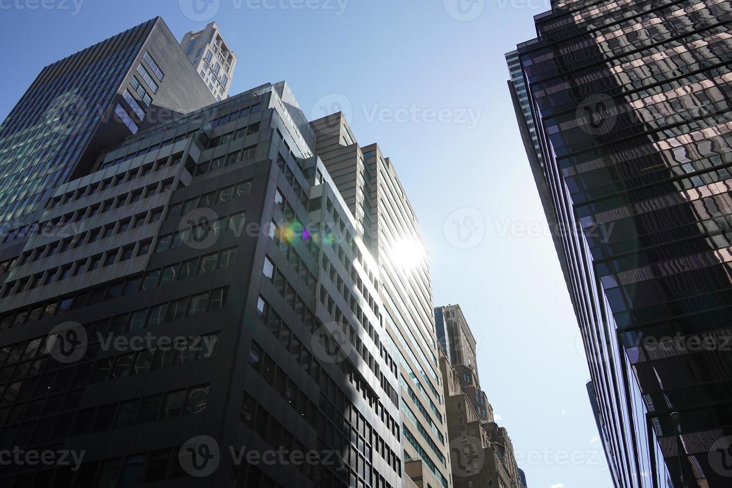 new york manhattan skyscrapers view from the street to the top of the building on sunny clear day photo