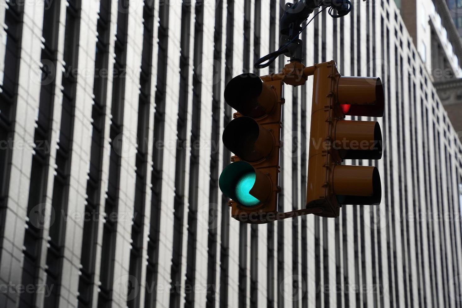 traffic light new york manhattan skyscrapers view from the street to the top of the building on sunny clear day photo