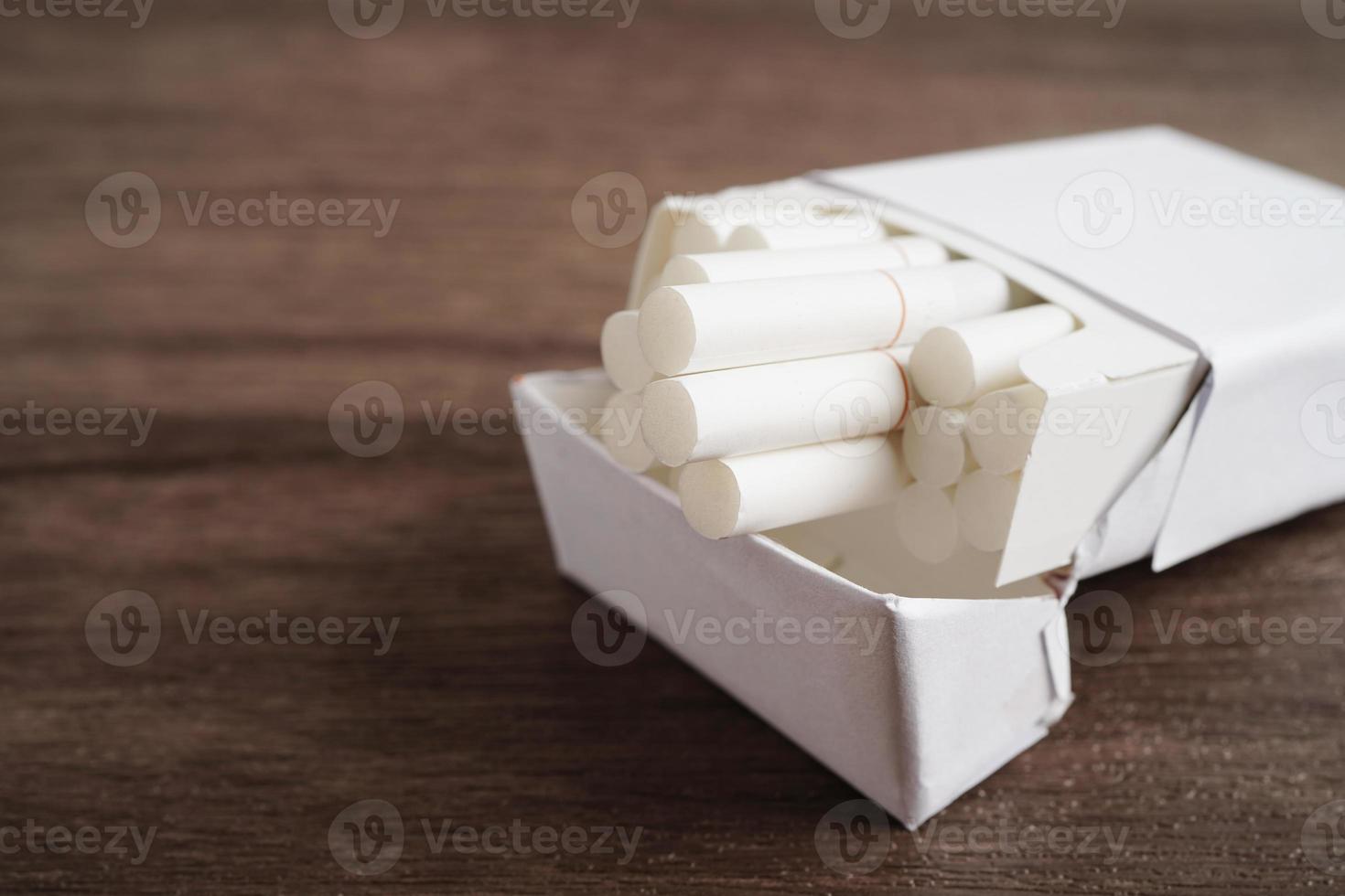 Cigarette in pack, roll tobacco in paper with filter tube, No smoking concept. photo