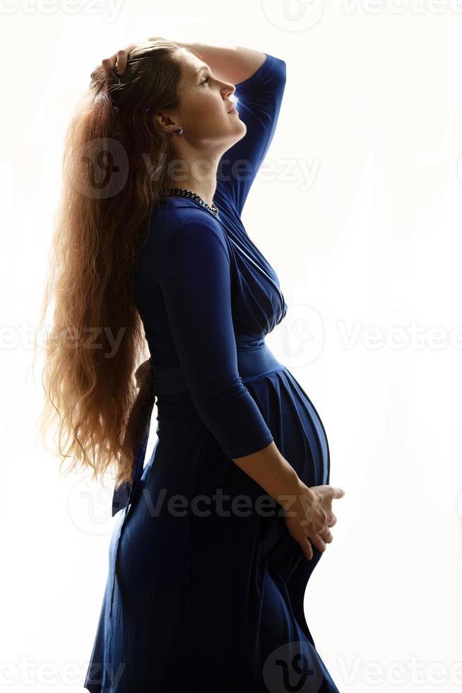 Beautiful pregnant woman on a white background. photo