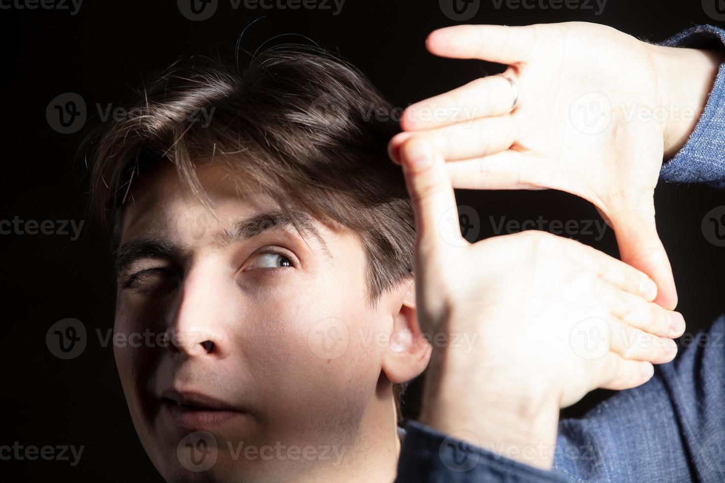 A man shows a camera with a sign photo