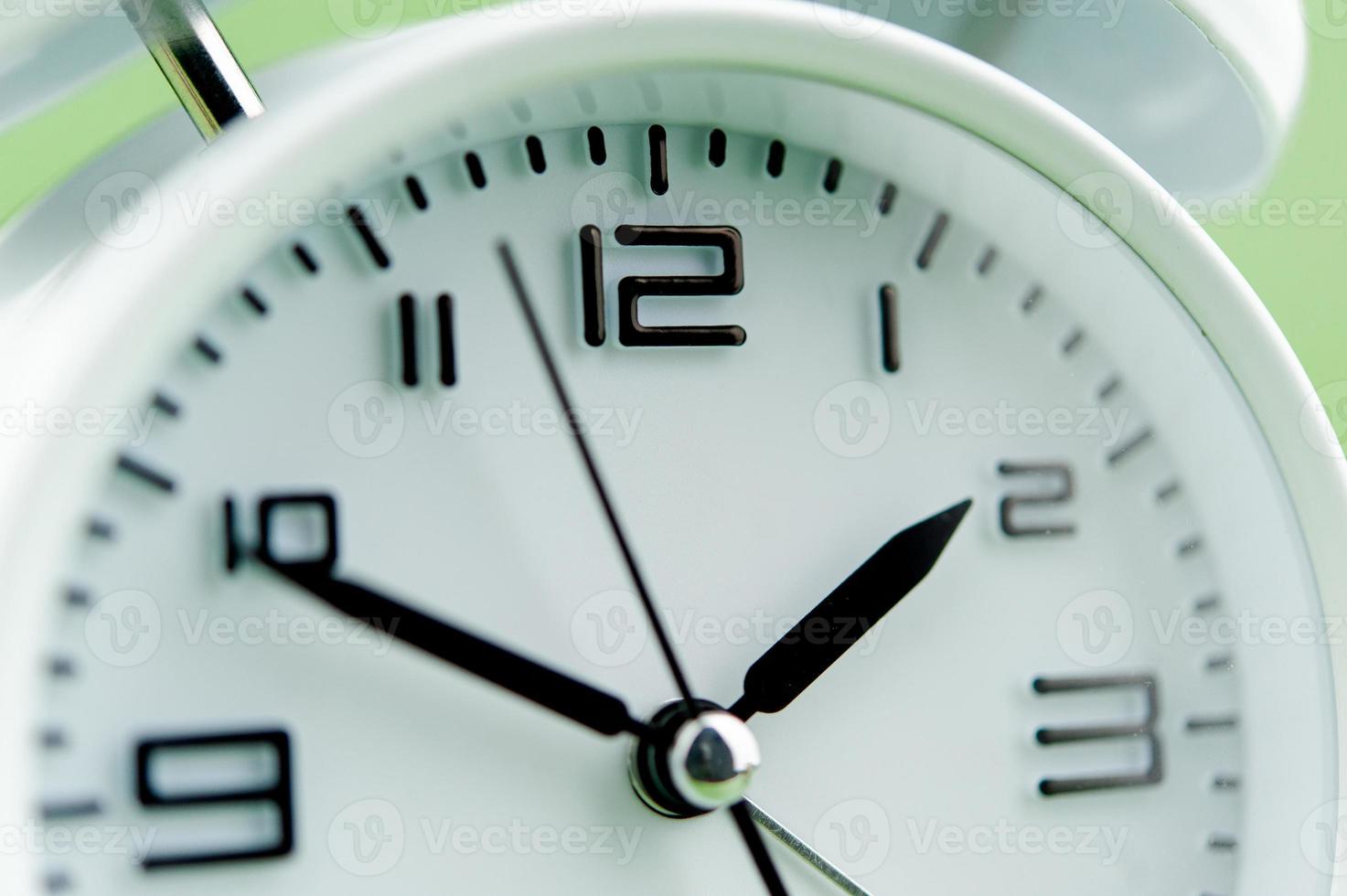 alarm clock on green background time concept working with time precious time photo