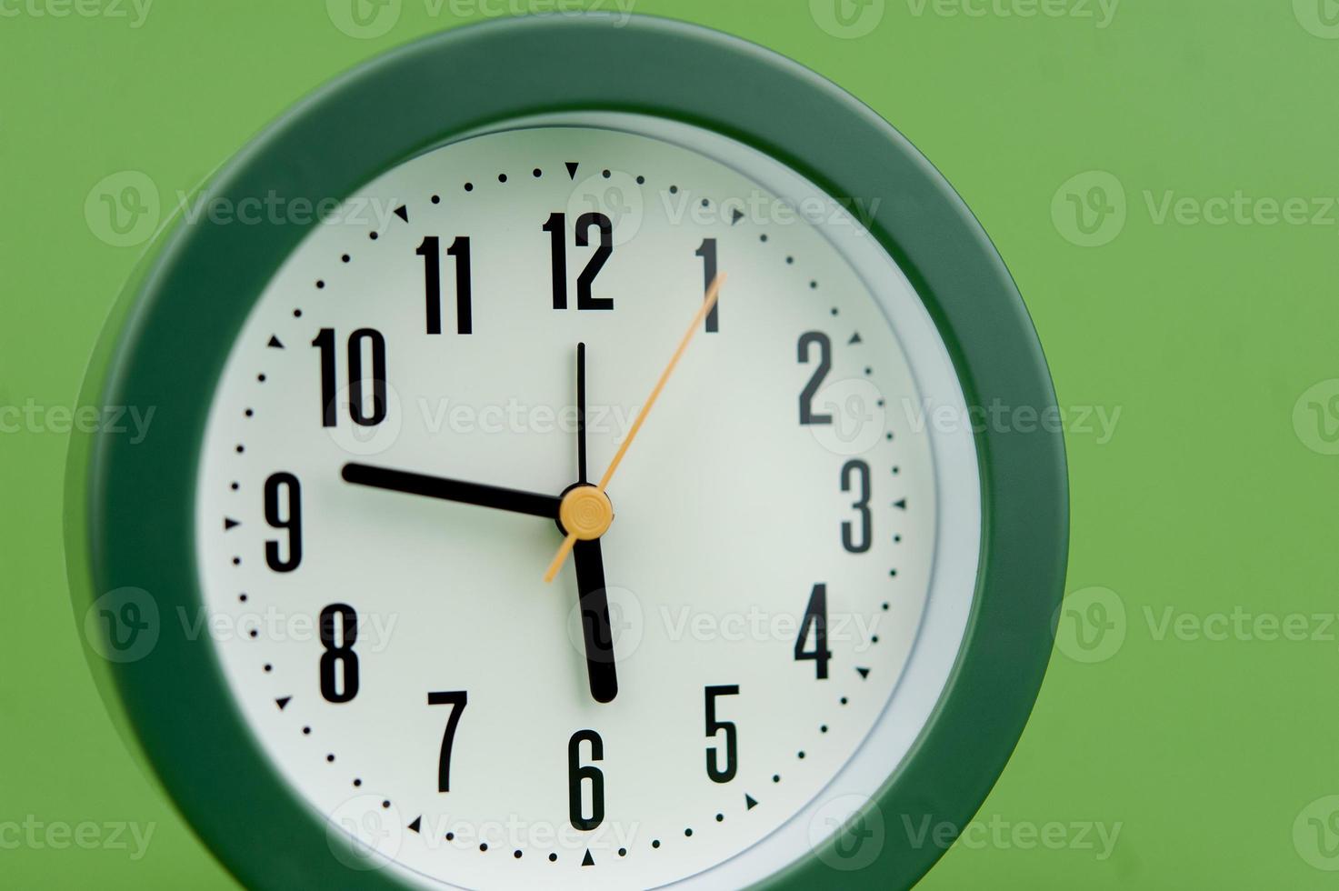 alarm clock on green background time concept working with time precious time photo