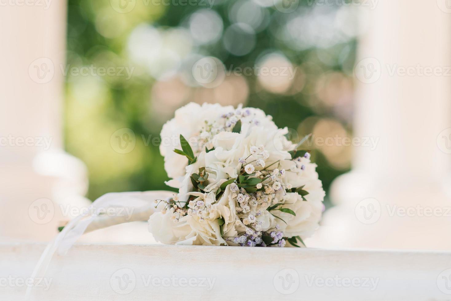 Delicate wedding bouquet with white hydrangea and greenery close-up photo