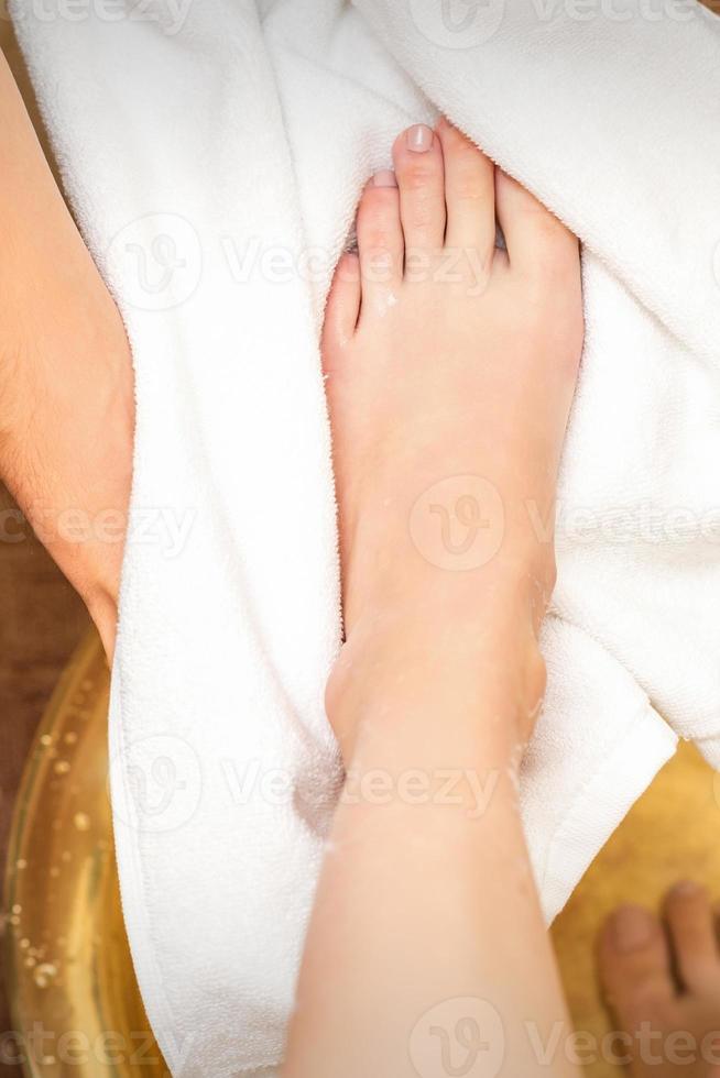 Therapist drying leg with towel photo