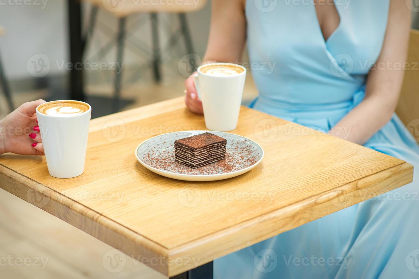 Two women with sitting at the table in cafe photo