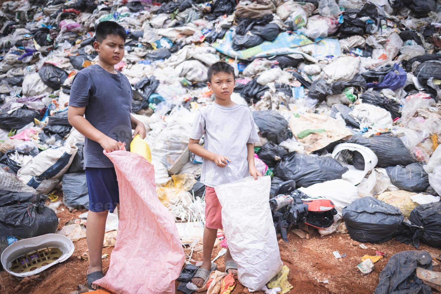 Children are forced to work on rubbish. Child labor,  Poor children collect garbage. Poverty, Violence children and trafficking concept,  Anti-child labor, Rights,  Day on December 10. photo