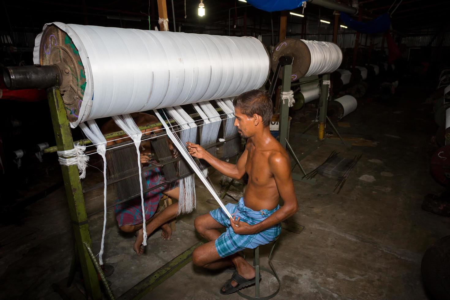 Bangladesh August 05, 2019 Yarn factory workers are rechecking newly made white yarn at Narsingdi, Bangladesh. photo