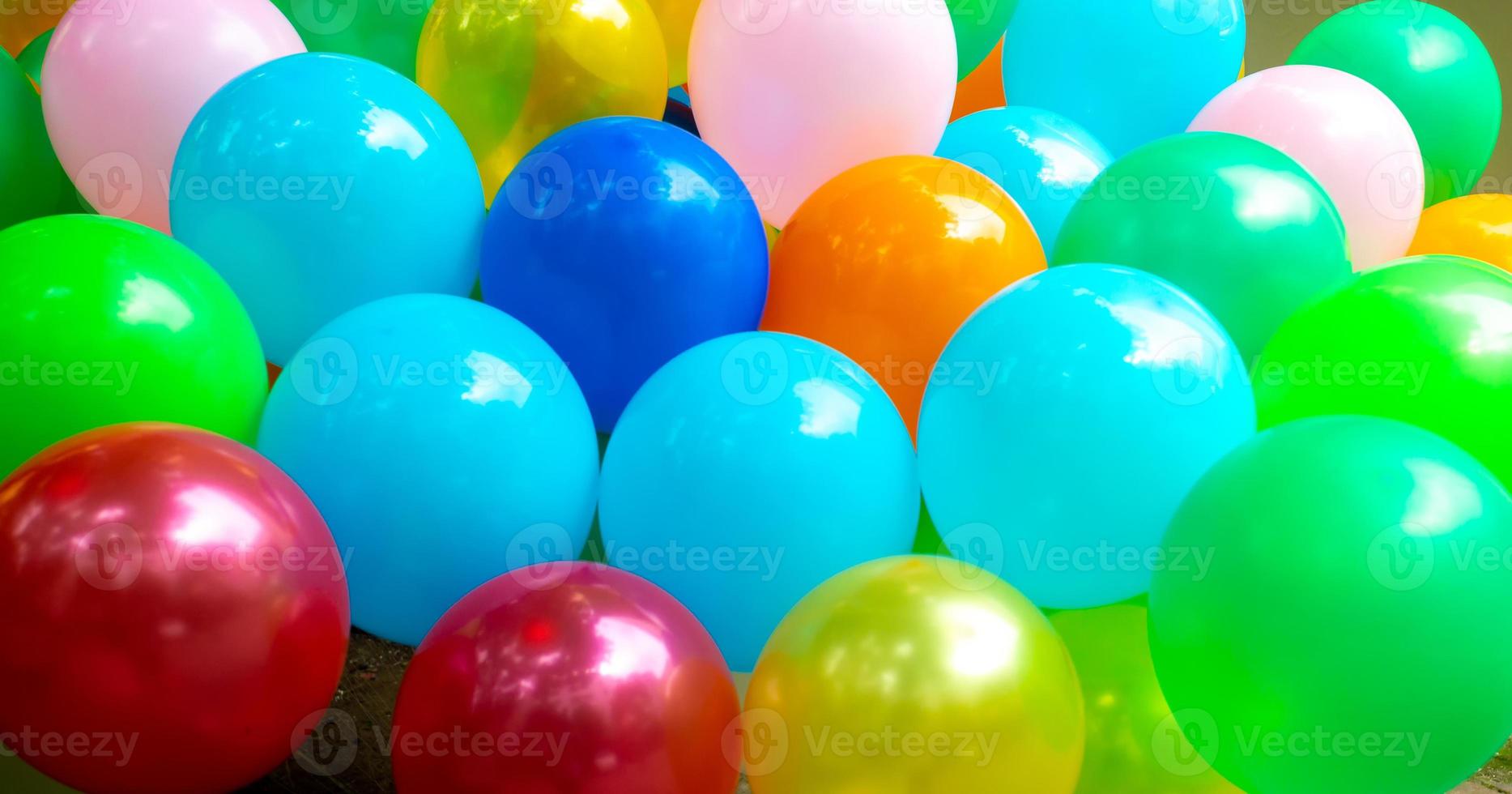 Light blue and green color-based colorful gas-filled balloons close-up views. photo