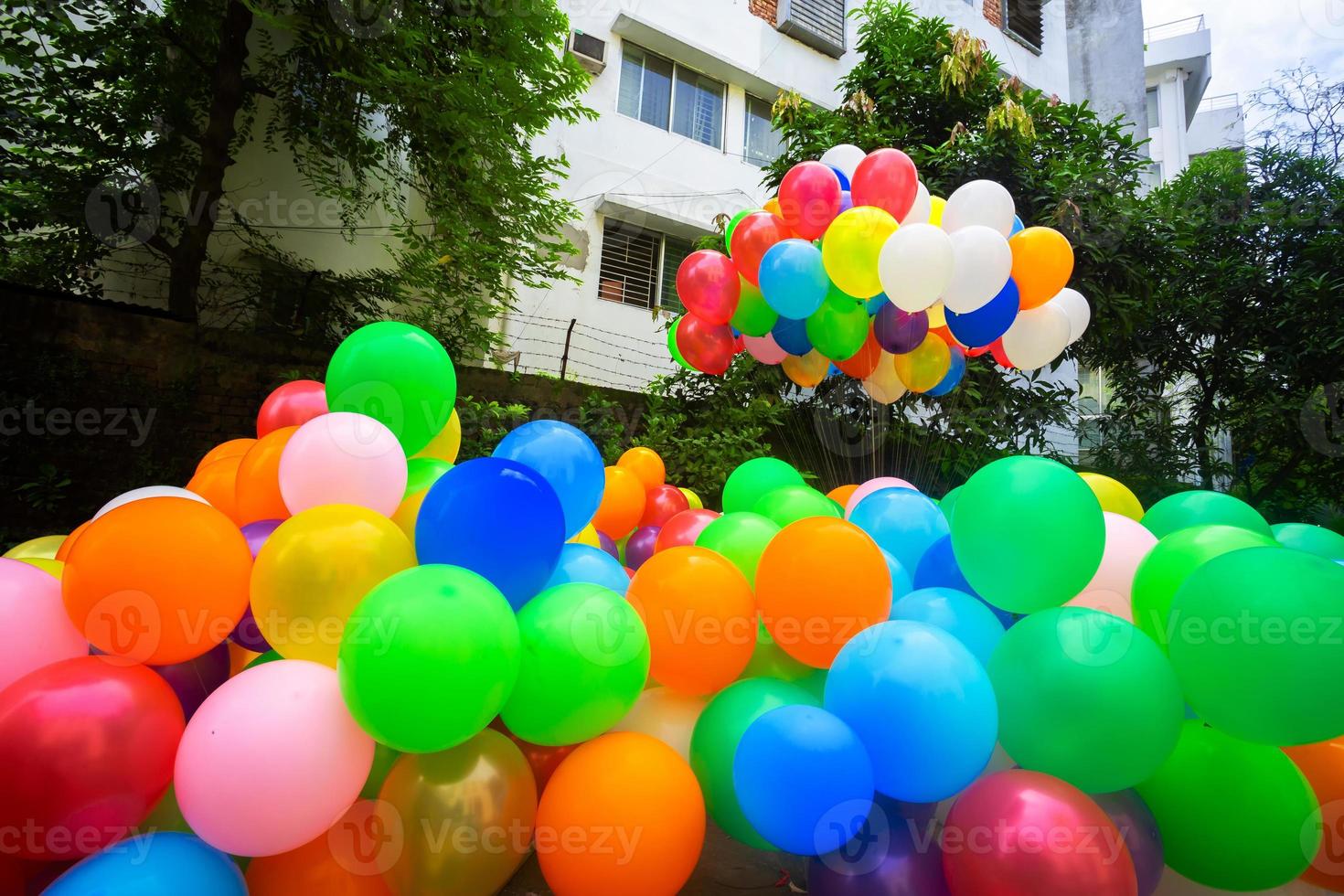 un pila de vistoso lleno de gas globos atascado en el hilo. foto