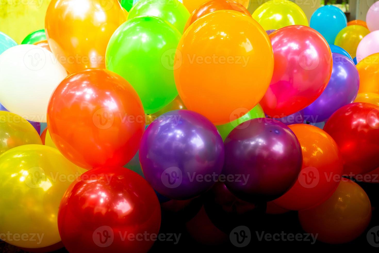 Deep orange and red color-based colorful gas-filled balloons close-up views. photo