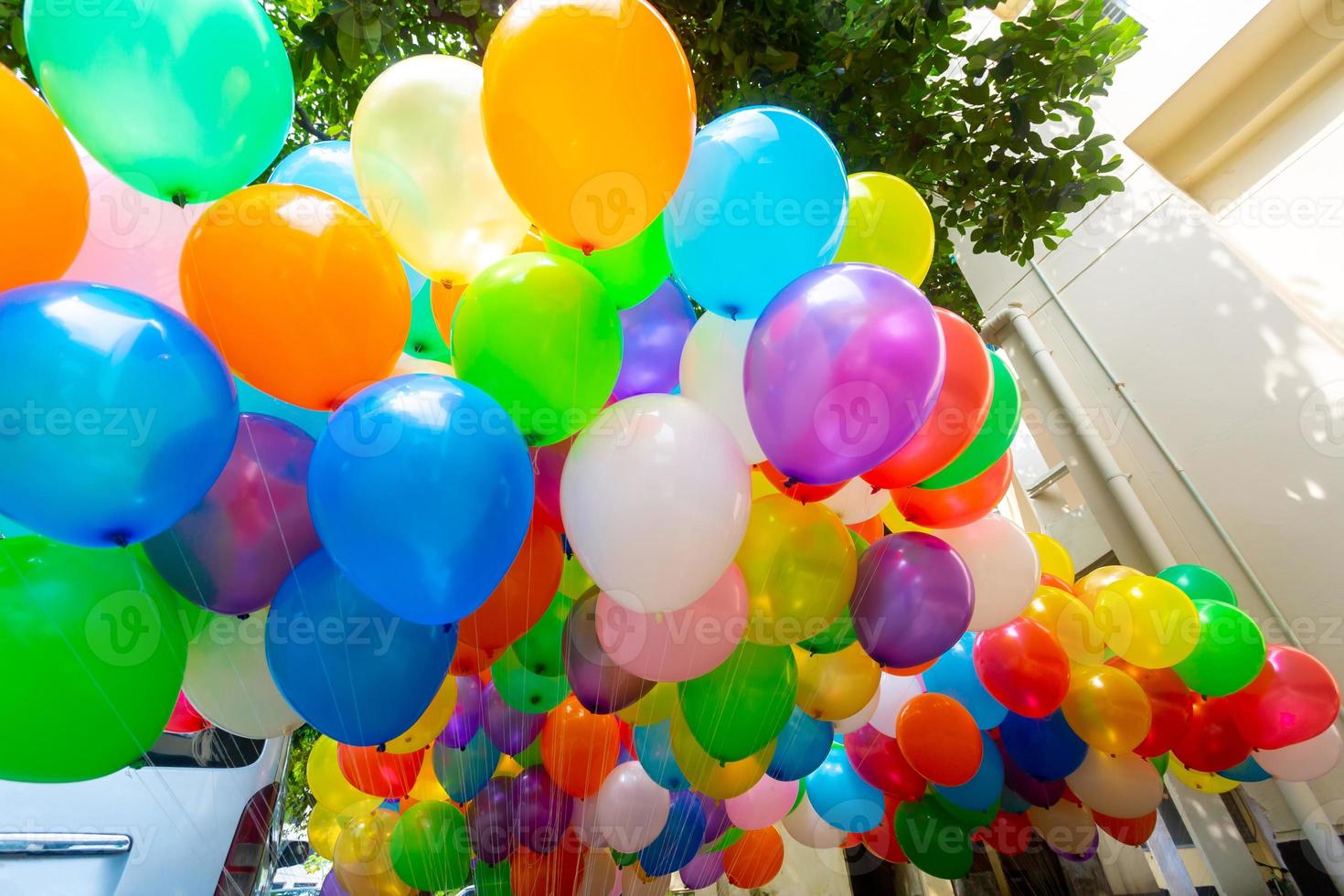 The colored gas-filled balloons attached to the yarn are flying. photo