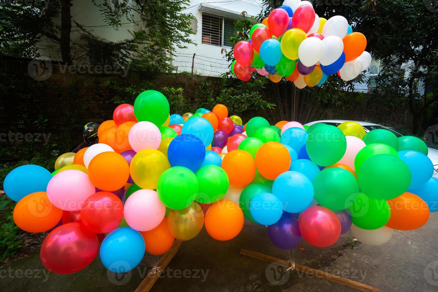 A pile of colorful gas-filled balloons stuck in the yarn. photo