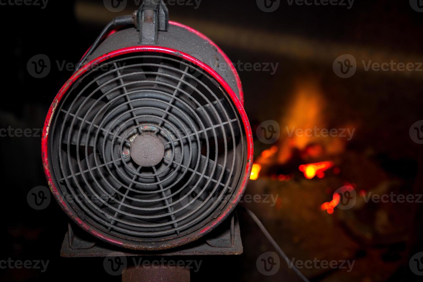 Industrial fan using hot scrap steel melting furnace in a local steel machine parts making yard Bangladesh. photo