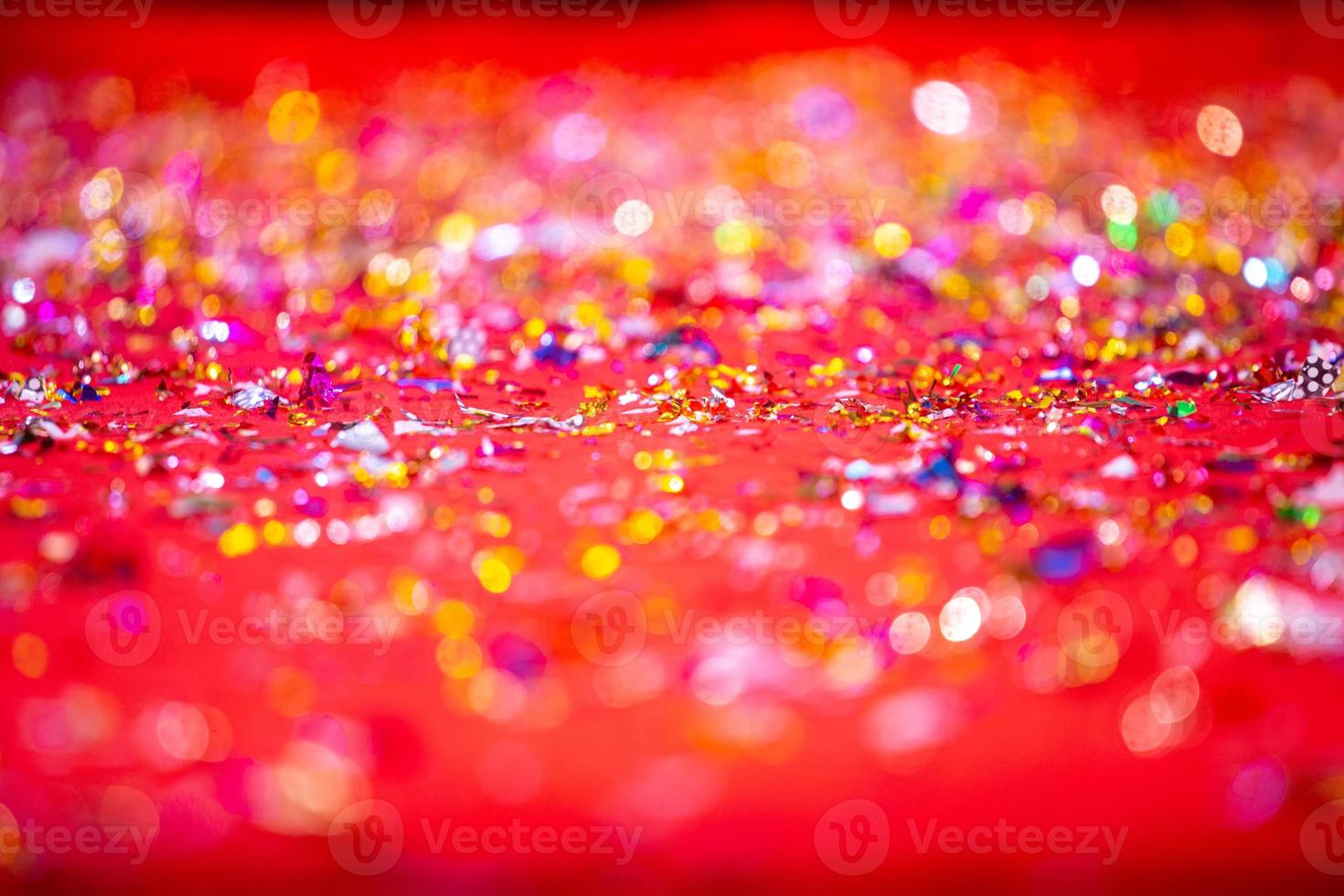 Gold or silver plastic laces cover on the red carpet. Red glitter texture abstract background. photo