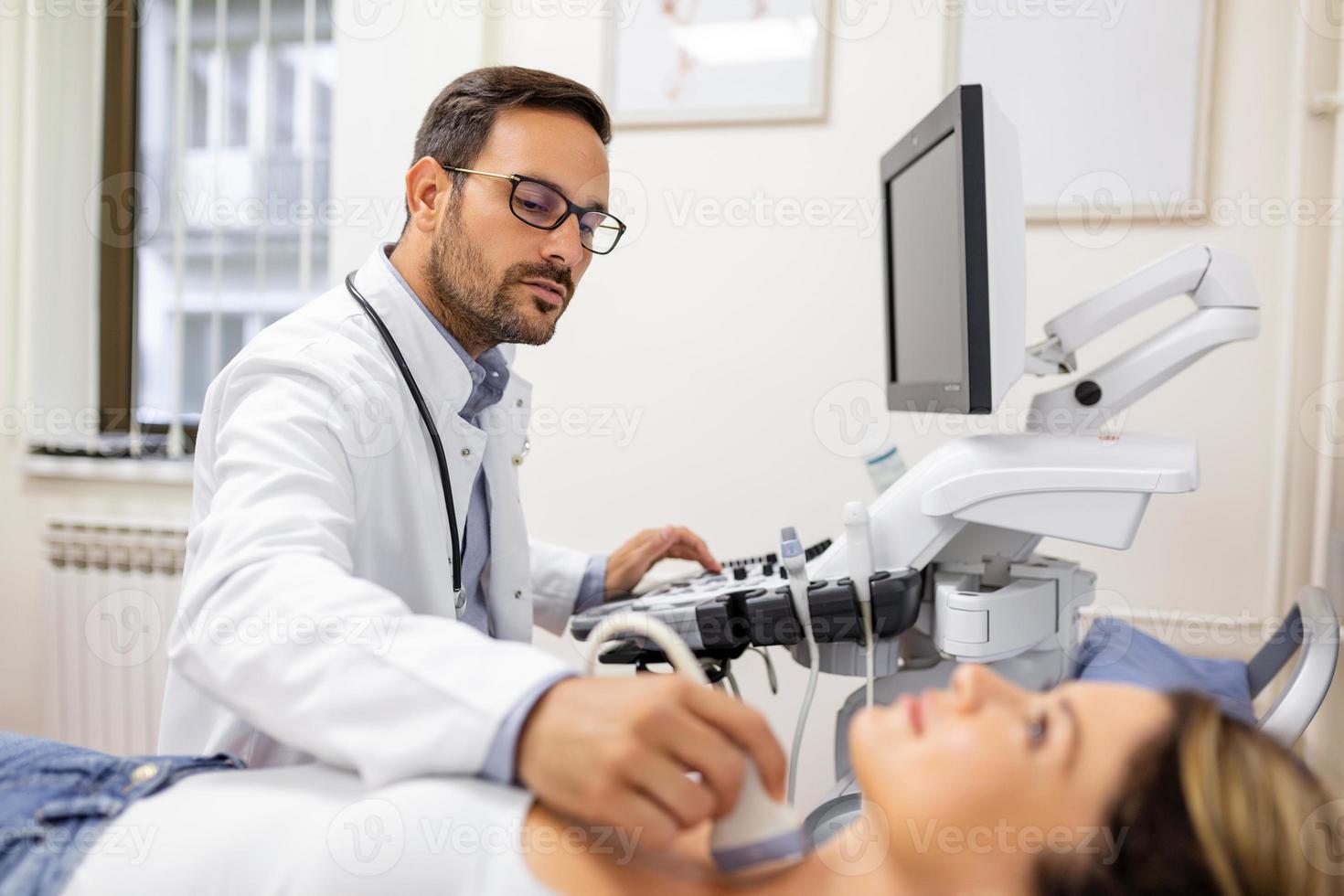 Woman patient receives thyroid diagnostics. Treatment of thyrotoxicosis, and hypothyroidism. Ultrasound diagnostics of the endocrine system and thyroid photo