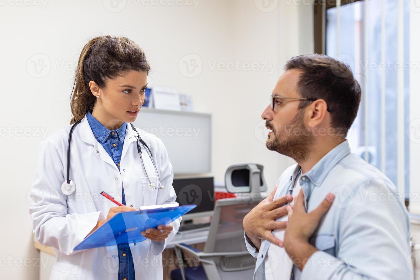 Experienced doctor discussing with patient his private medical file. Young man checking up with his MD, and consulting about the way of his health treatment and health insurance. photo