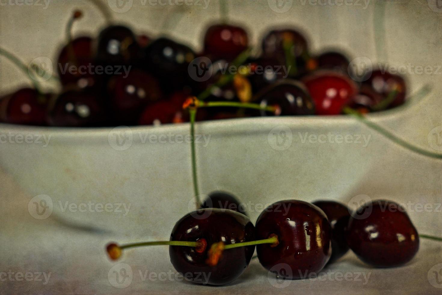 l juicy fresh summer cherries in a white bowl on a vintege background photo