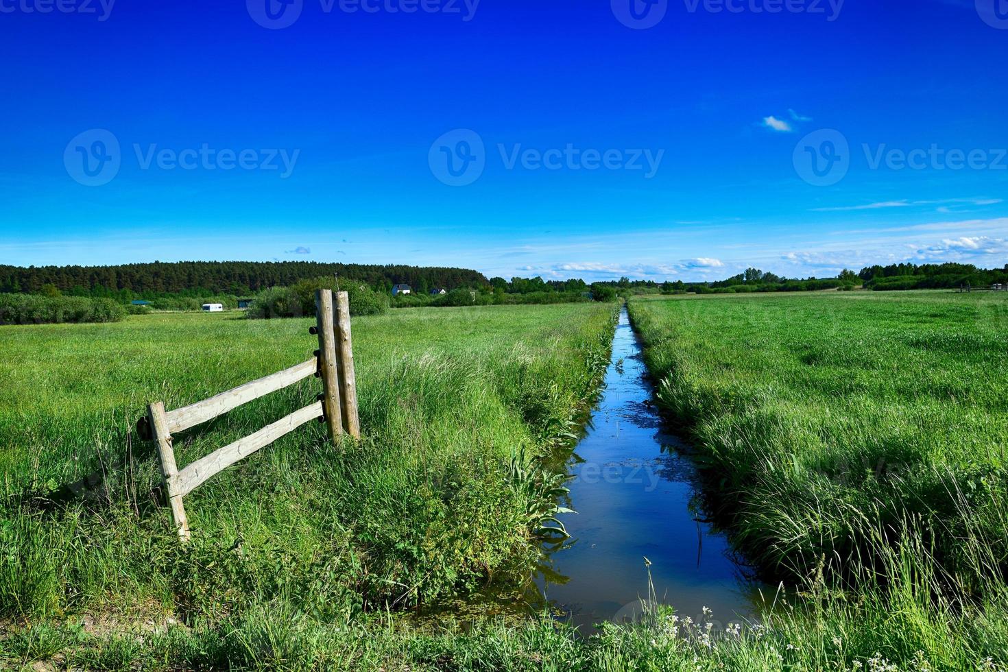 picturesque spring landscape with blue sky and green fields photo