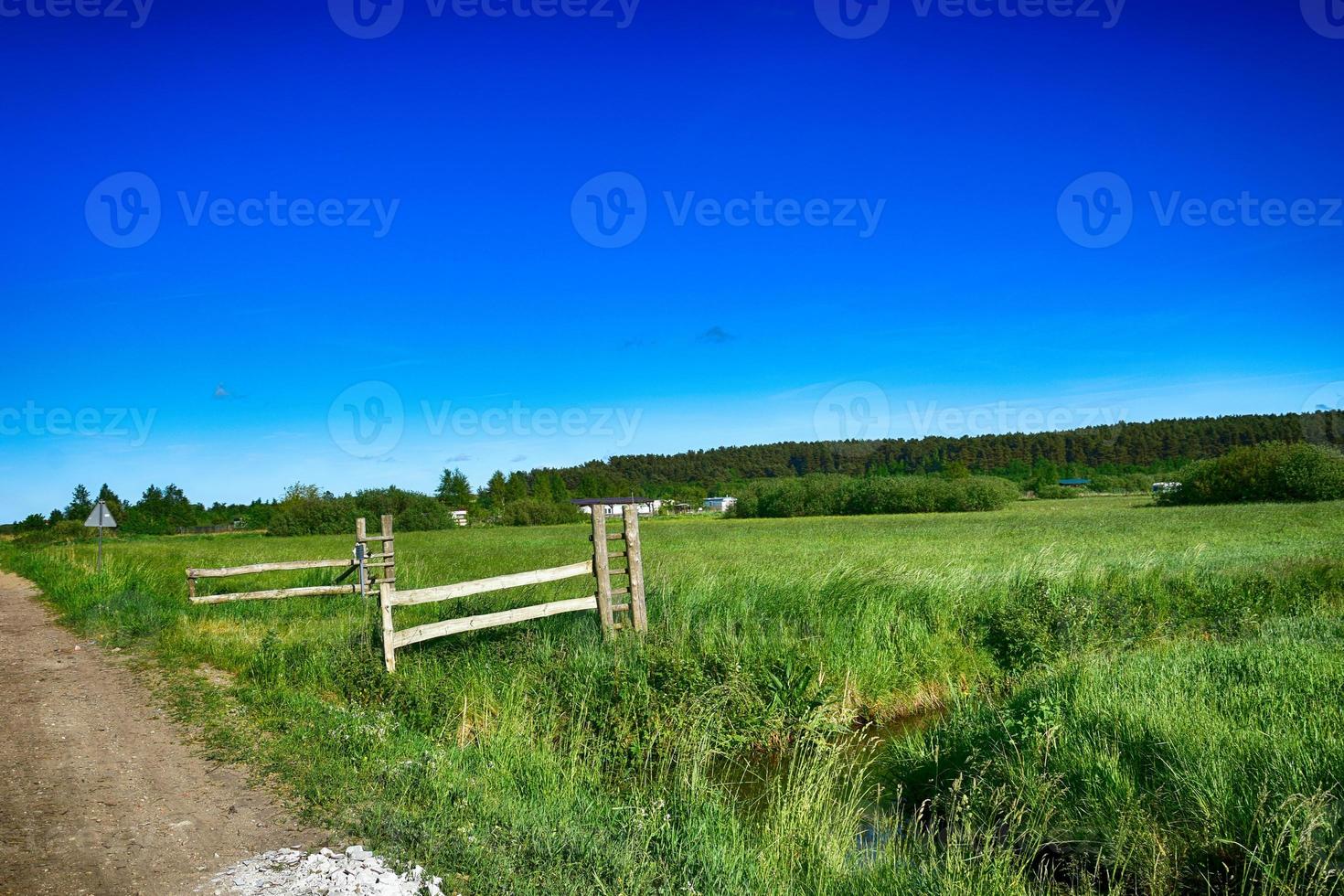 picturesque spring landscape with blue sky and green fields photo