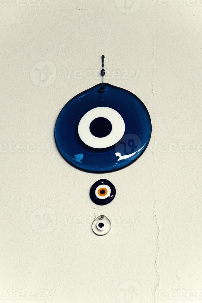 the  Turkish eye of the prophet hanging on the white wall as a decoration to deter bad luck photo