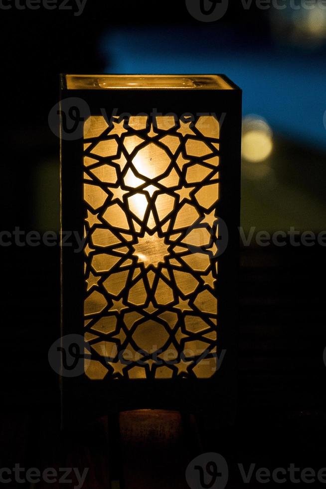 original oriental lamp shining with warm light during the coming dark photo