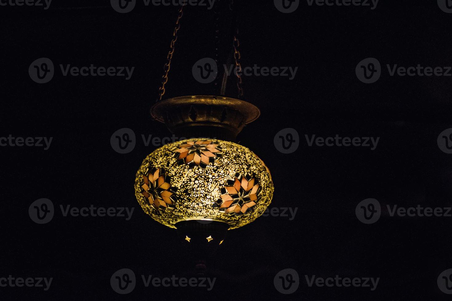 original oriental lamp shining with warm light during the coming dark photo