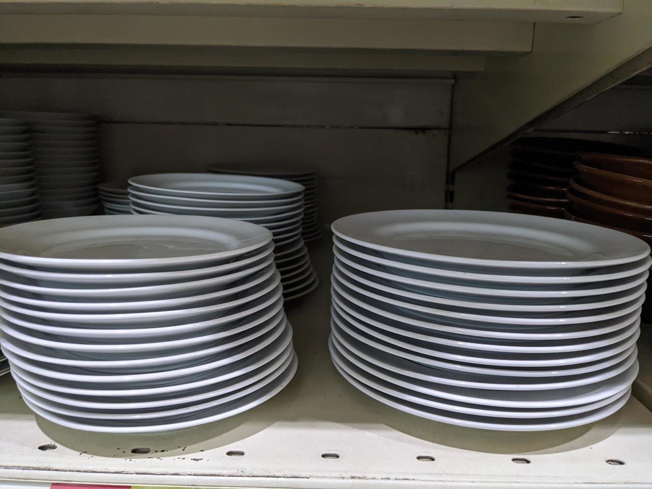 Lot of bowl and plate on the rack mini market. The photo is suitable to use for promotion picture and discount background.