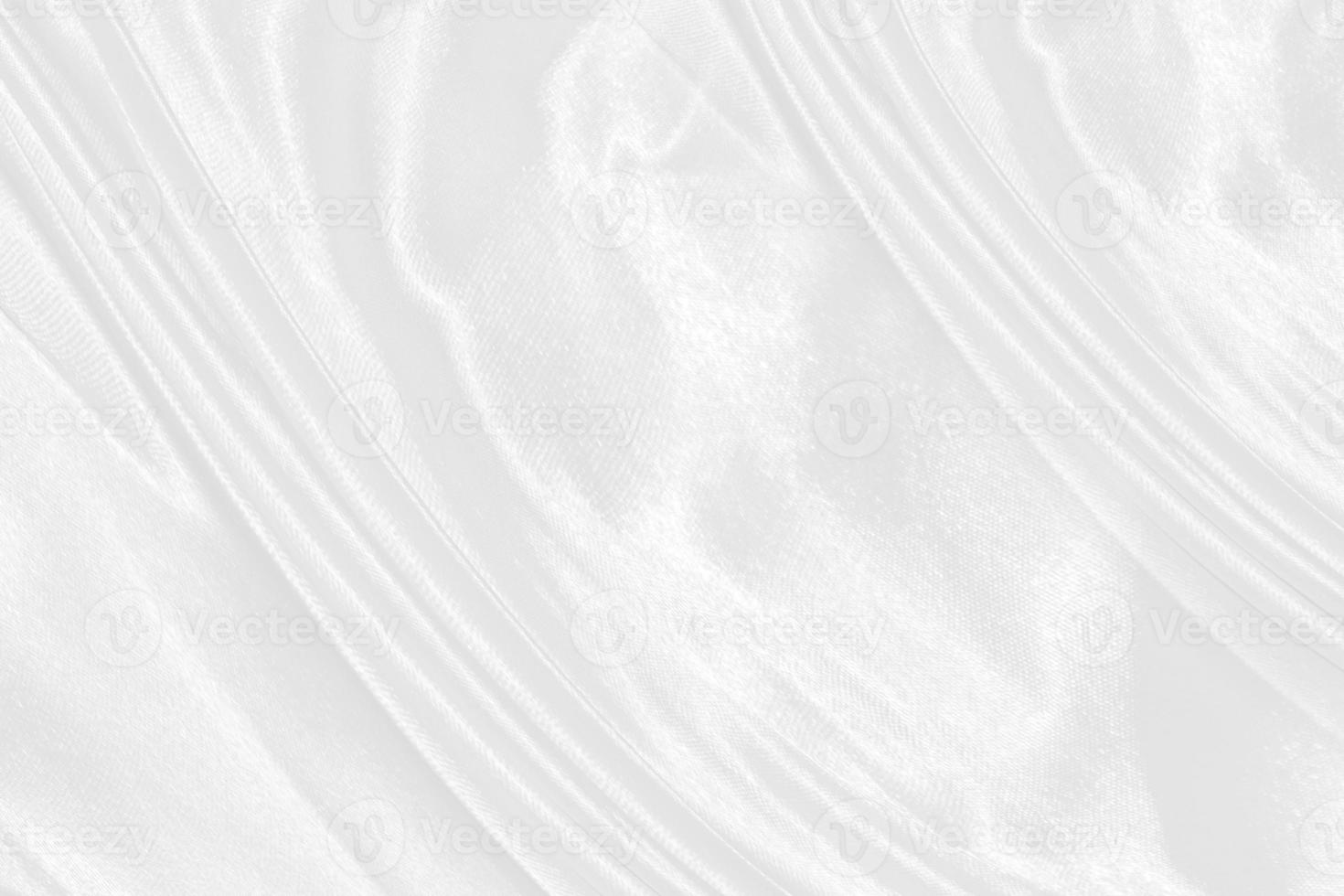 white silk textured cloth background,Closeup of rippled satin fabric with soft waves. photo