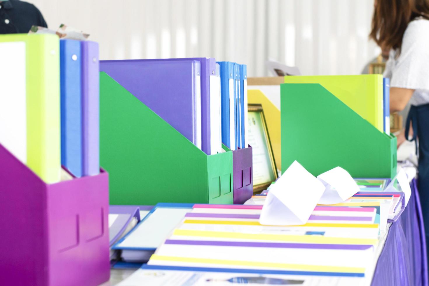 Colorful folders of personnel and office staff are kept and sorted in boxes in the office to evaluate their performance in order to raise their salary or increase their annual remuneration. photo