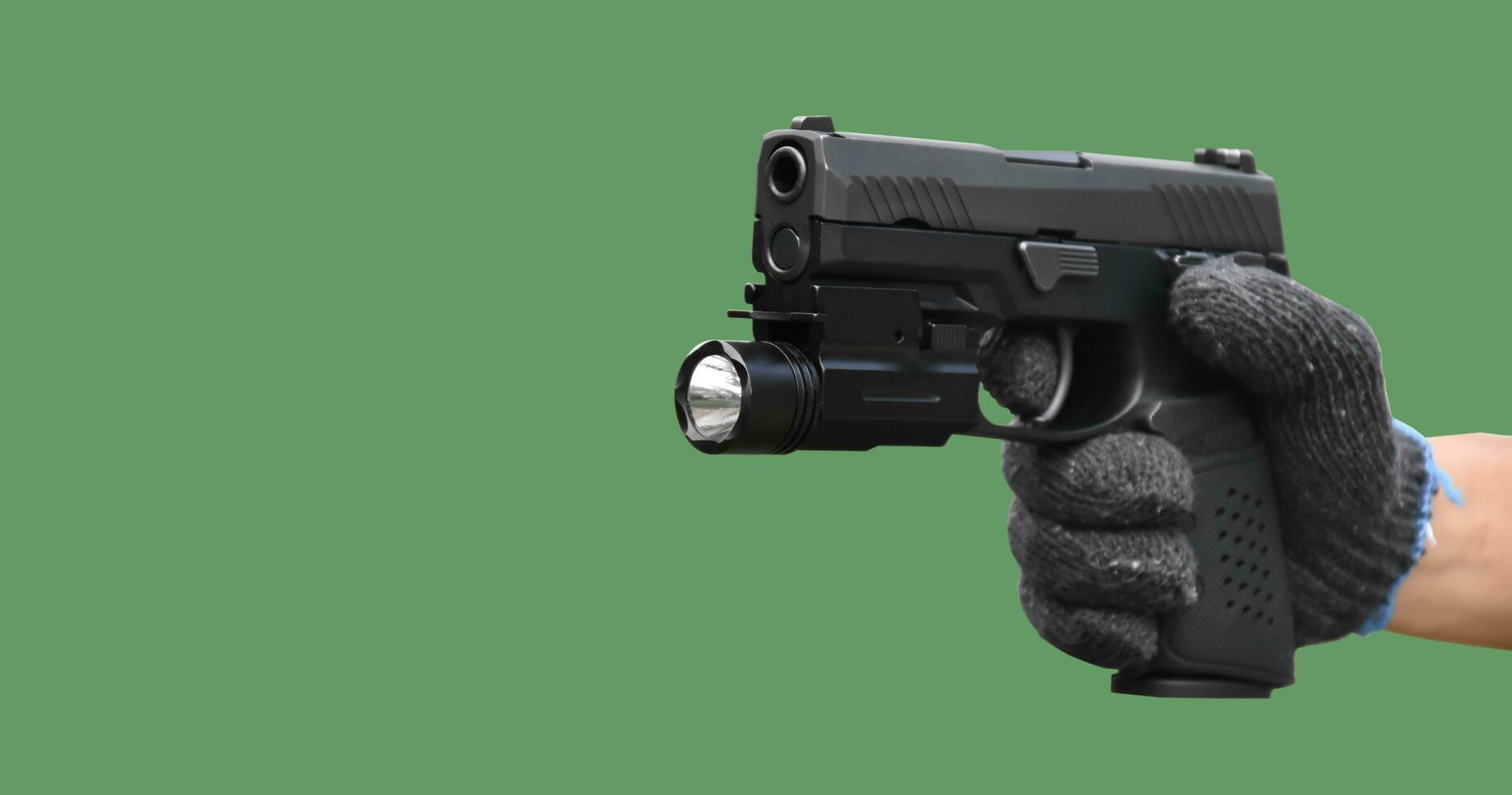 Isolated 9mm pistol gun holding in right hand of gun shooter with clipping paths. photo