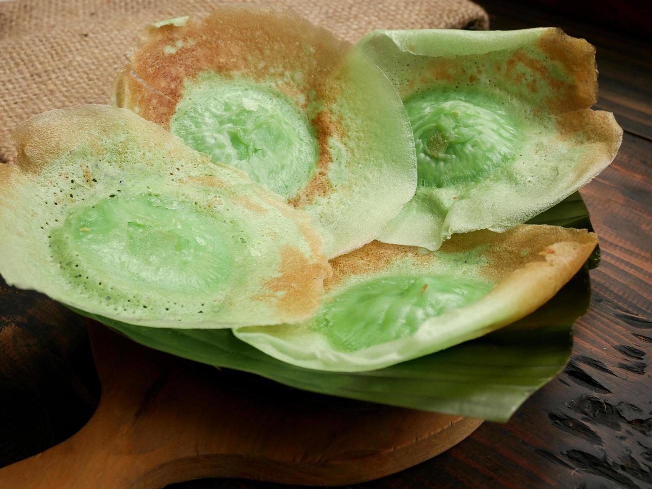 Indonesia Traditional Cake, Kue Ape stacked on wood plate photo