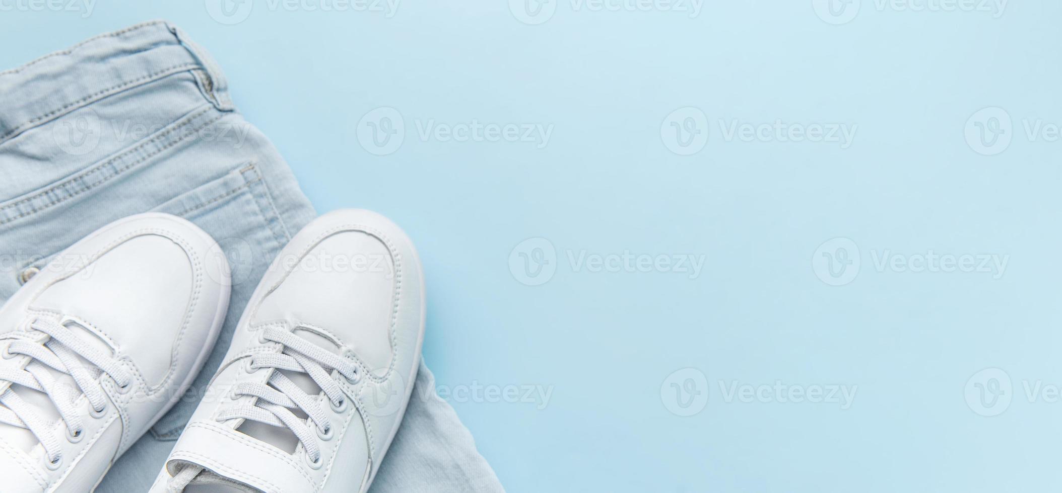 Banner Set of children jeans and white sneakers, casual style. photo