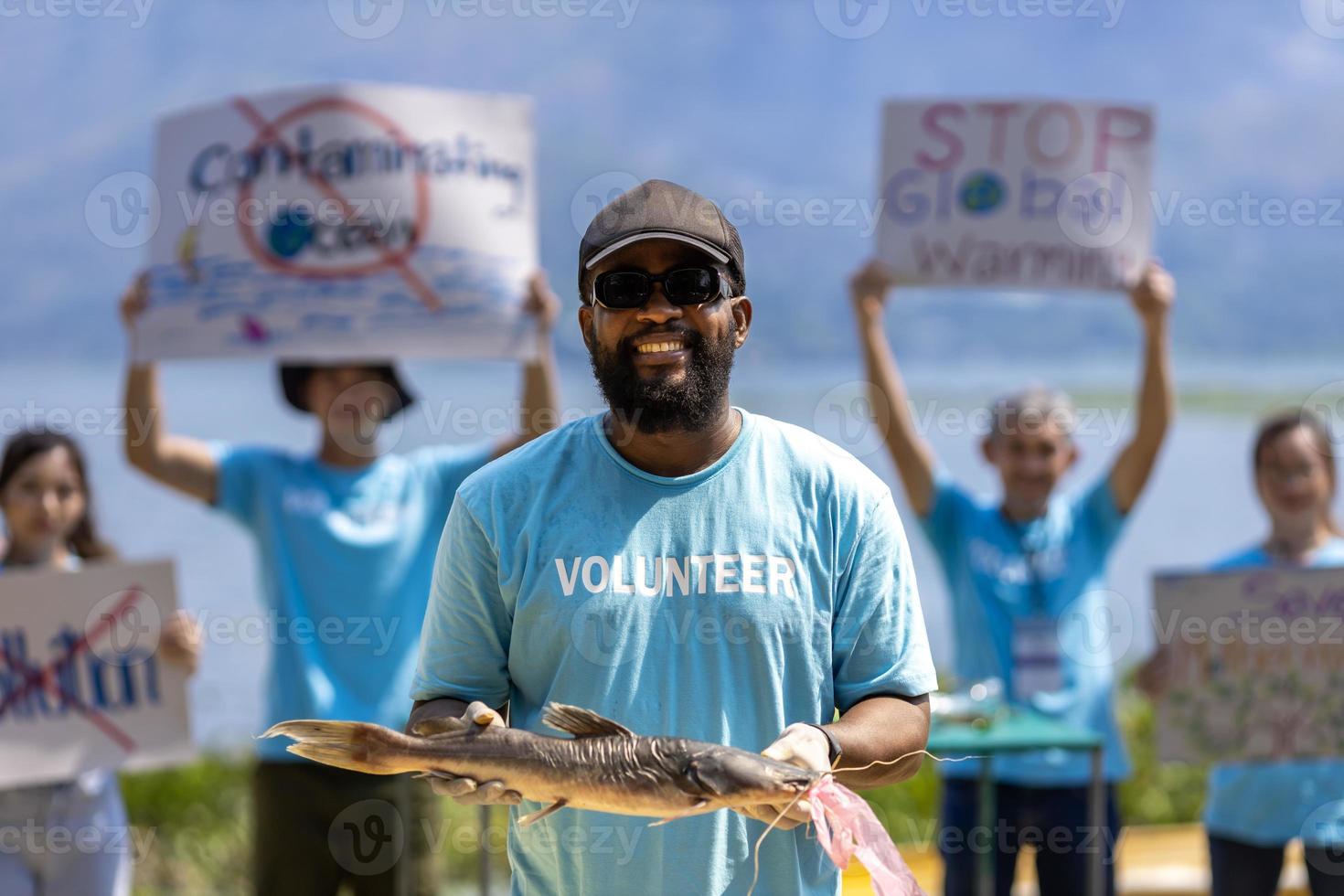 Team of ecologist volunteers are demonstrating rally at ocean for climate change and saving nature concept with protest sign against pollution and sea contamination for wildlife and biodiversity photo