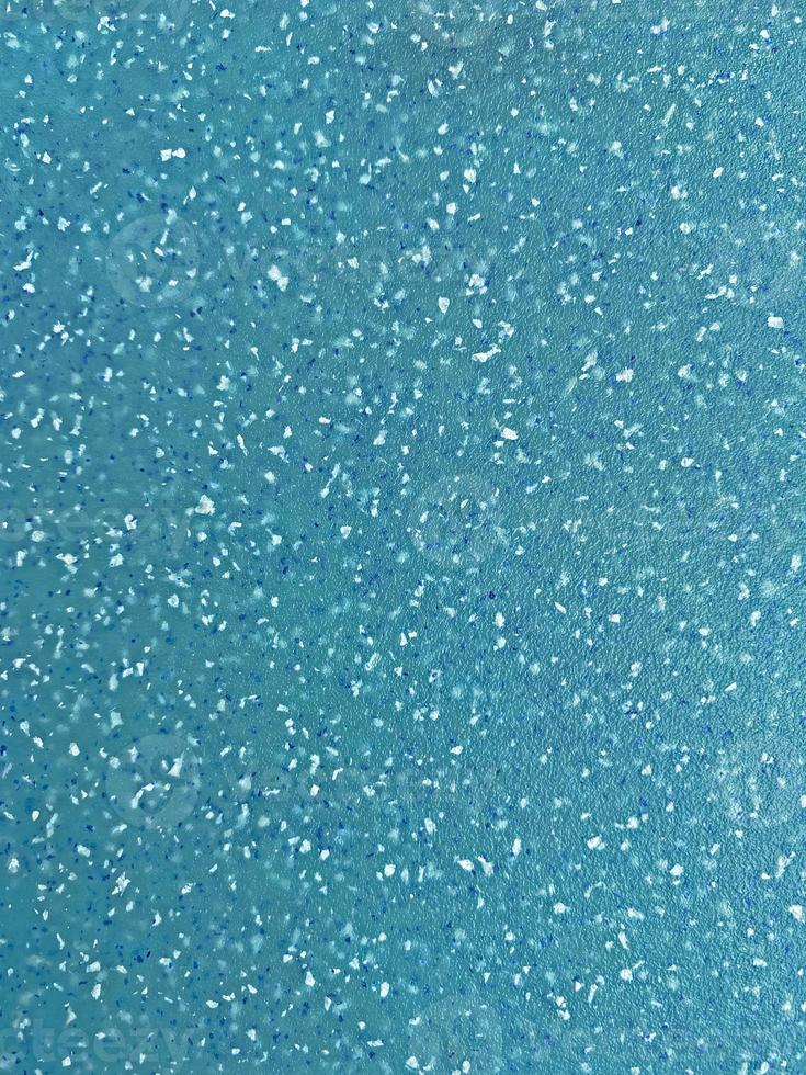 close up of aqua plastic board with crumbs pattern photo