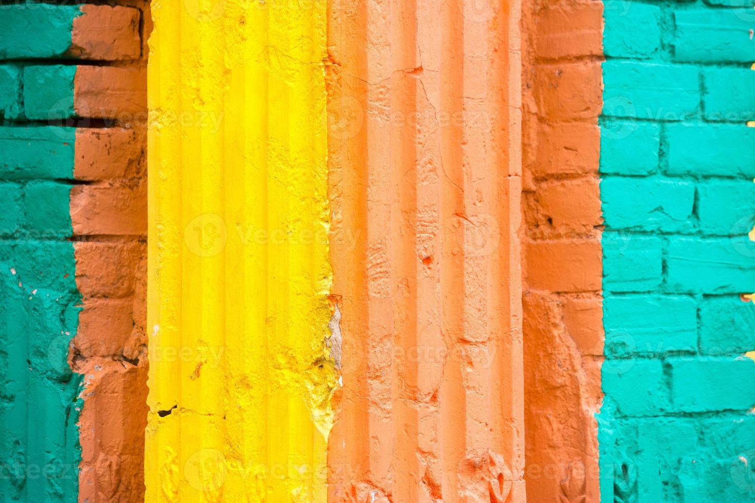 Red, Orange, yellow and blue color combination old Textured damage wall with Colorful Bricks. photo