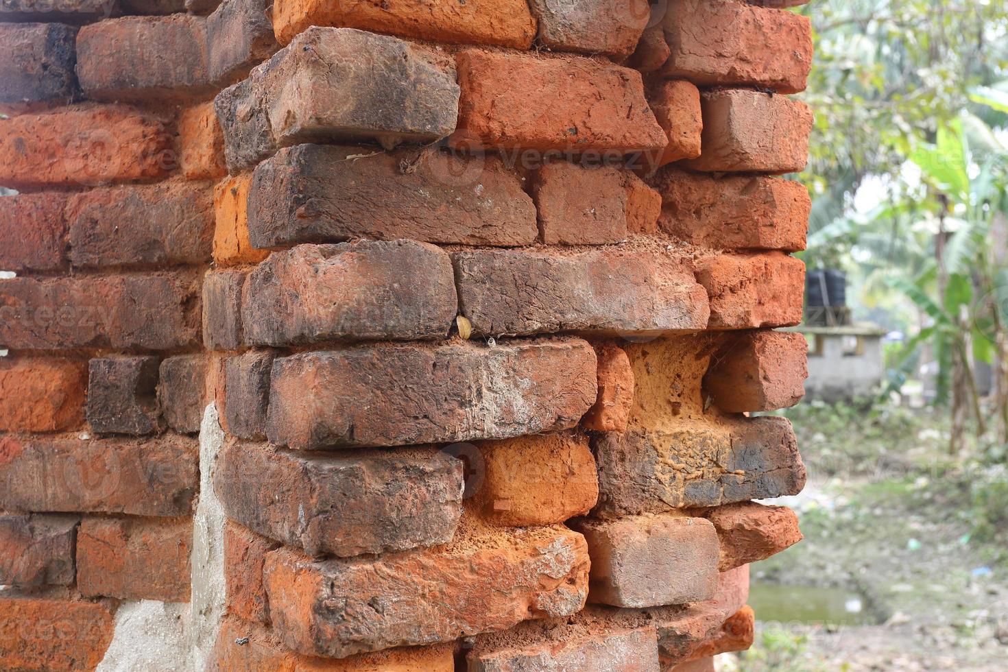 Old orange and red breakable brick arch wall with pattern. photo