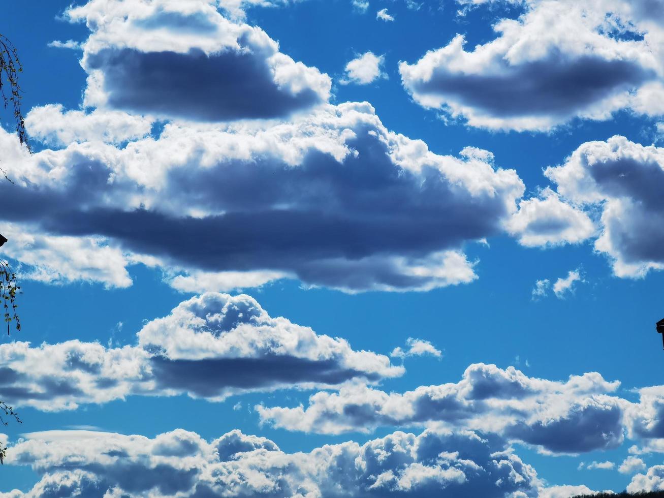 texture of white fluffy clouds on a blue sky during a warm spring day in 2023 photo