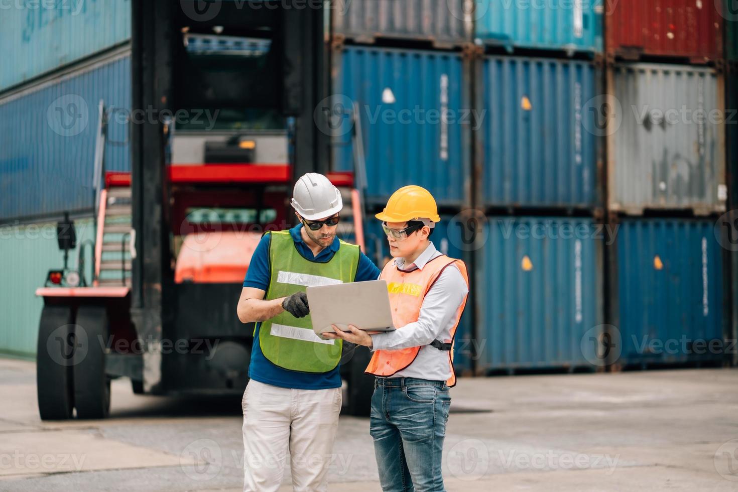 Team Engineer and worker wear safety uniform check control loading freight cargo container use computer laptop at commercial dock warehouse,transportation import,export logistic industrial service photo