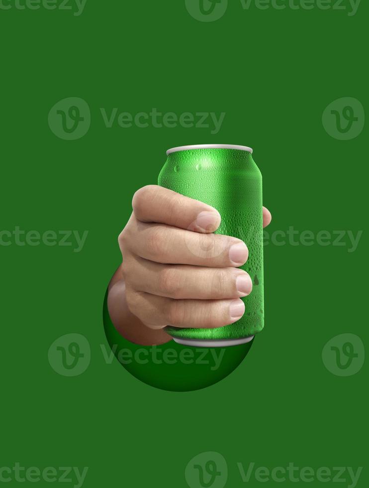 Man holding aluminum can with water droplets on green background photo