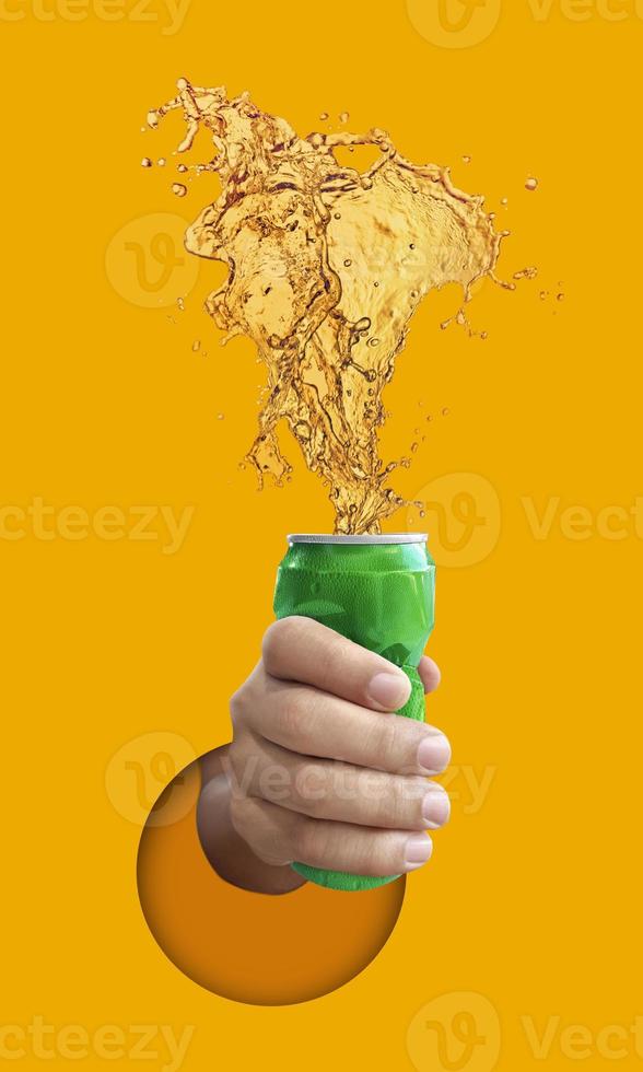 Man holding Cold beer splashing out of caned, on yellow background photo