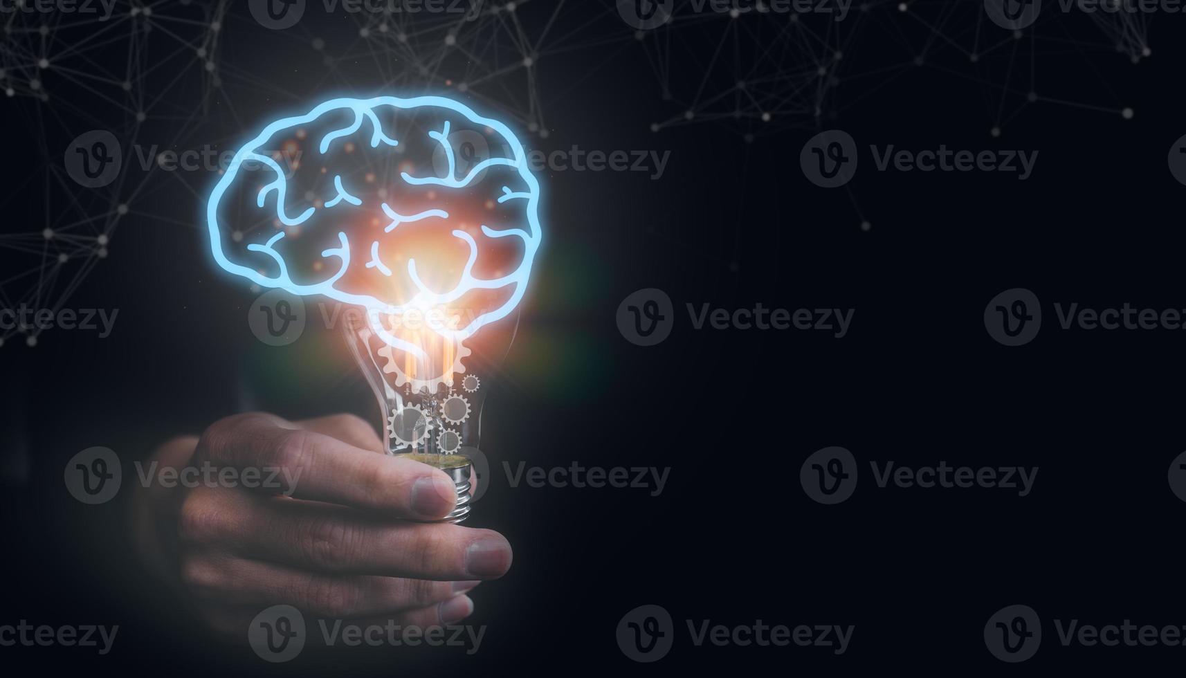 idea and creativity concept. man holding light bulb with virtual brain and gear icons, idea, innovation and inspiration concept photo